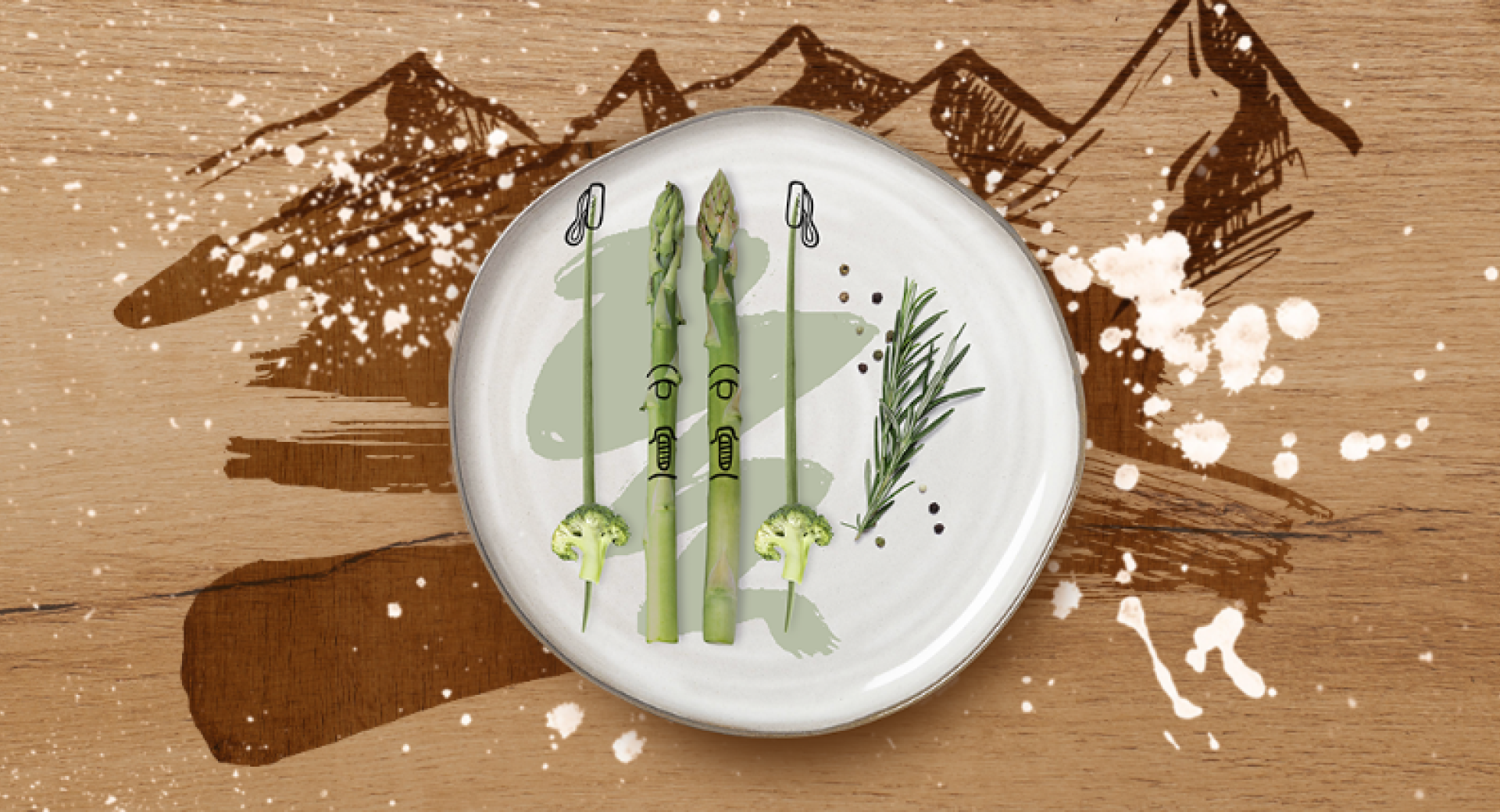Asparagus on a white plate, background brown with a mountain illustration.