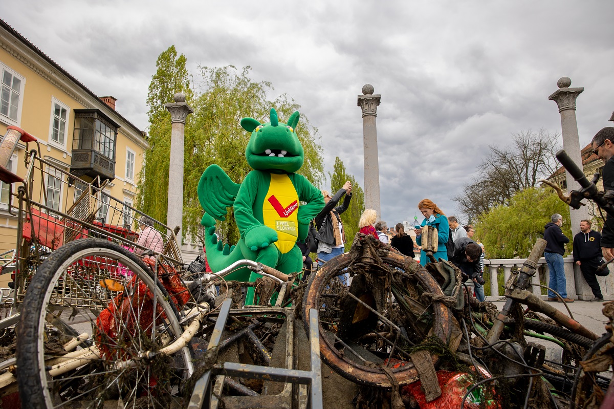 Odpadki iz Ljubljanice po njenem čiščenju leta 2022, ob njih ljubljanska maskota Zmajček