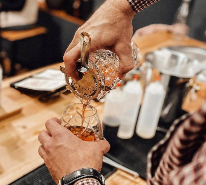 Pouring a drink into a glass.