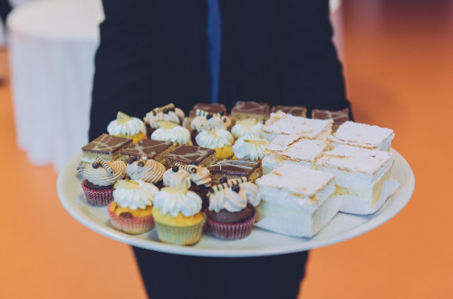 A large white plate with various desserts.
