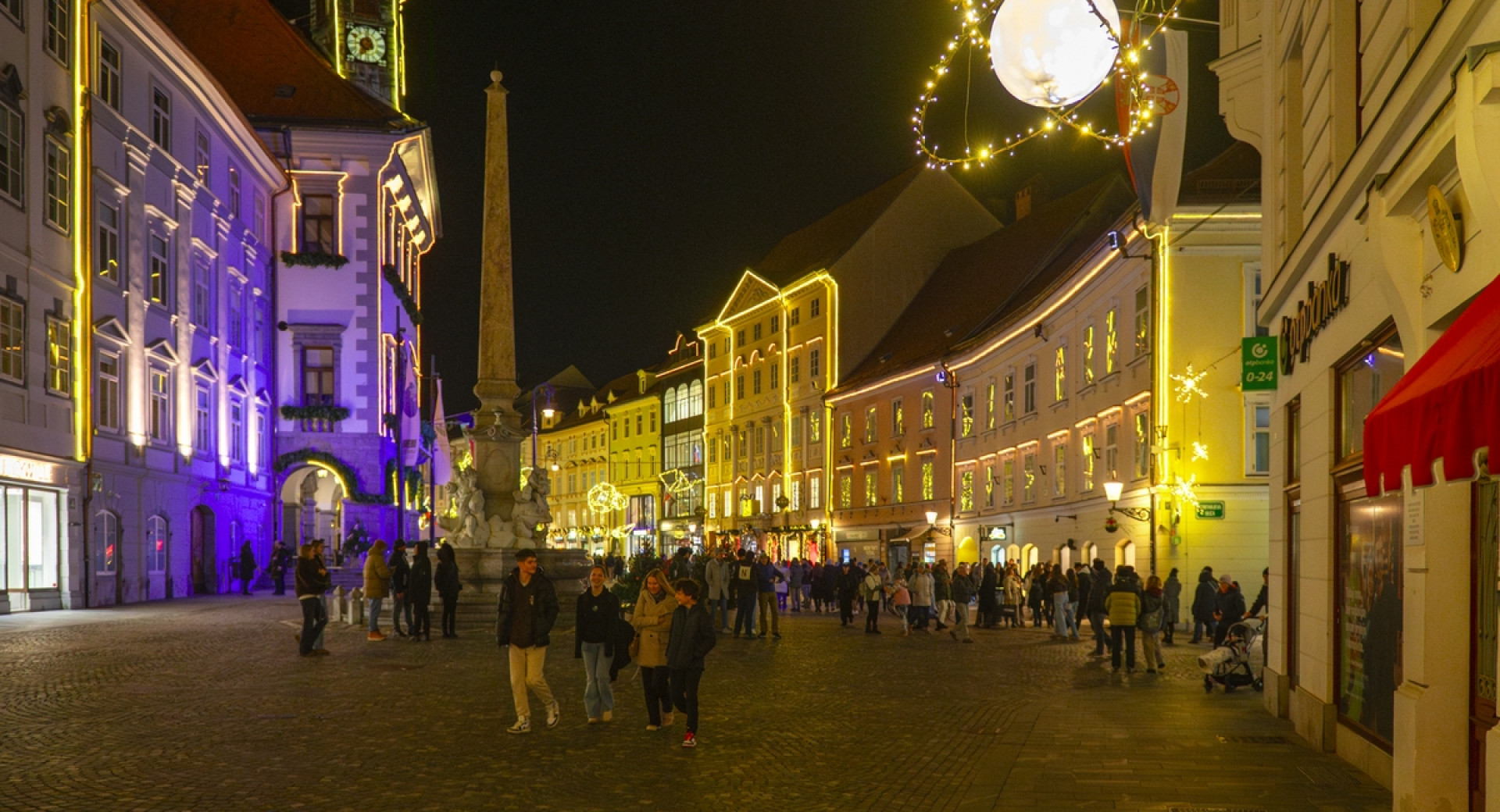 Obiskovalci v novoletno okrašeni Ljubljani.