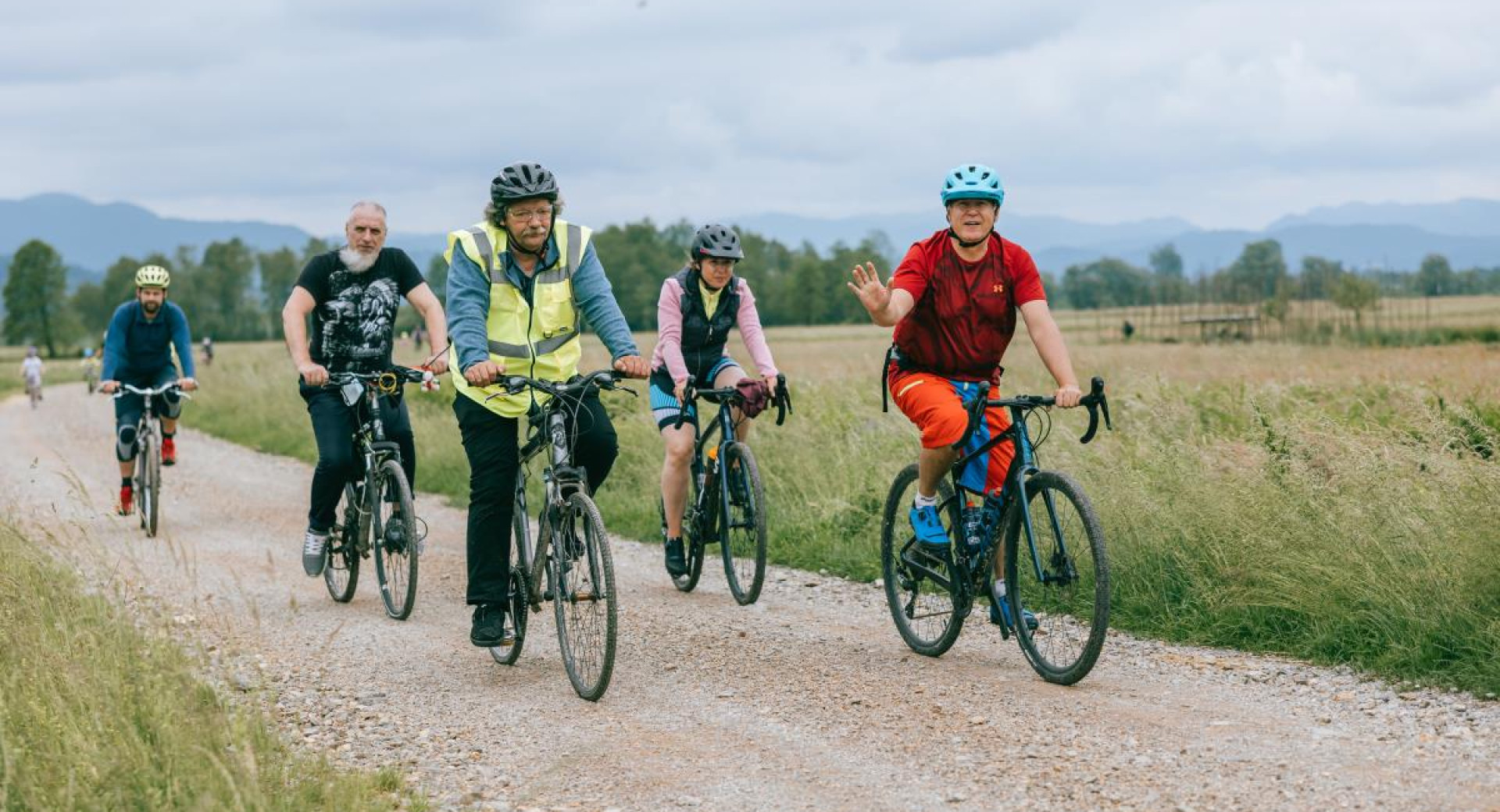 A small group of cyclists on a gravel road.