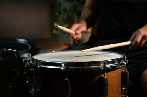 A drummer plays the drums.