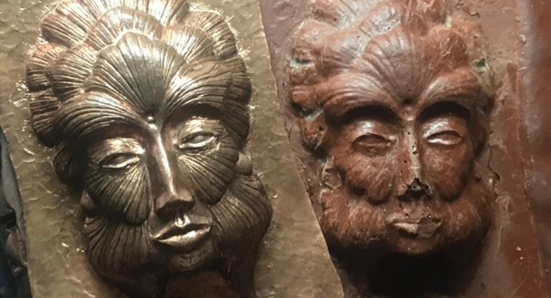 Dva obraza odtisnjena na kovini.