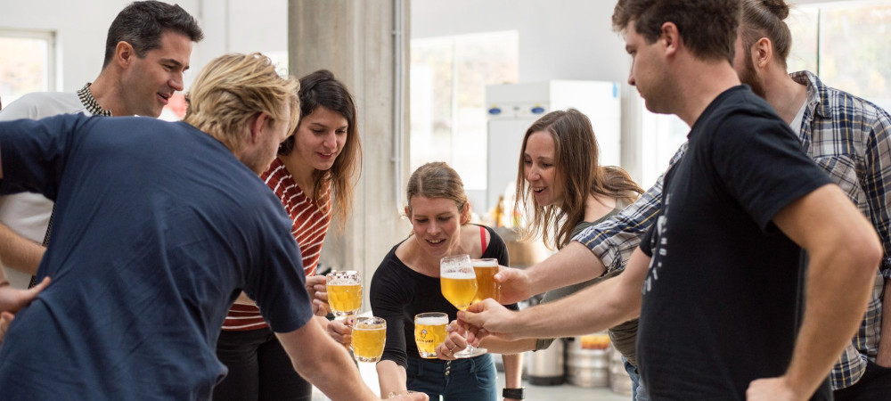 People toast with beer.