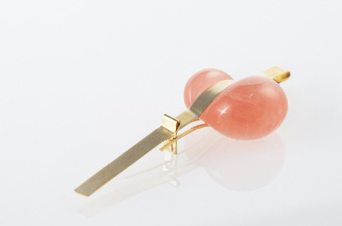 A pink stone set in a gold clip.
