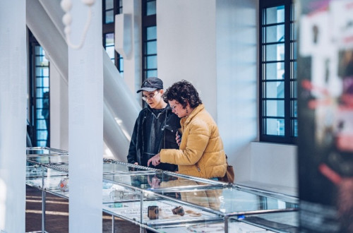 Two visitors viewing a jewellery exhibition.
