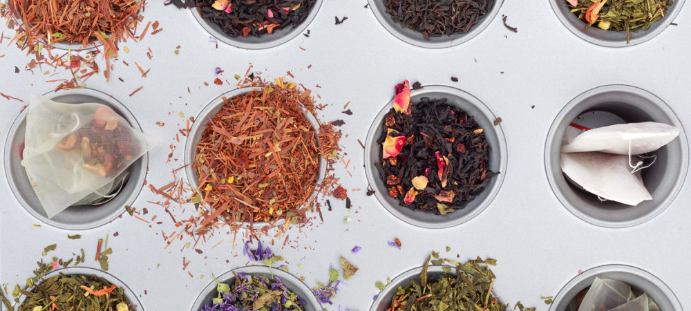 Overhead shot of teas and tea bags. The tea leaves come in different colors.