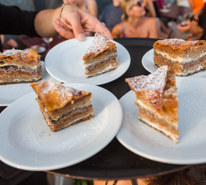 Cinque piatti con Prekmurska gibanica. Un dolce con mele, ricotta e semi di papavero.
