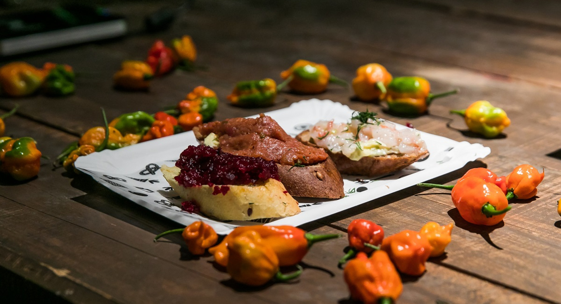Food on a white plate on a wooden table.