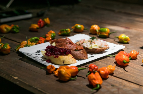 Food on a white plate on a wooden table.