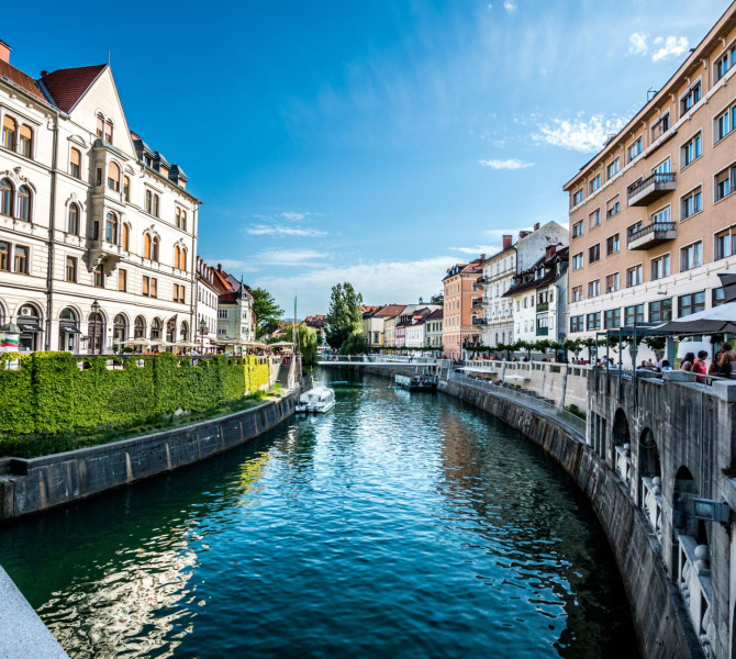 The river flows through the city, with houses lining the embankments.