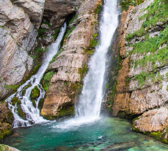 Une double cascade se jetant dans un petit lac.