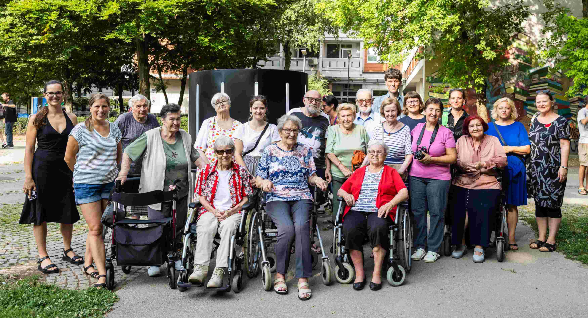 A group photograph of the residents of the Centre Retirement Home in Ljubljana, taken outdoors.