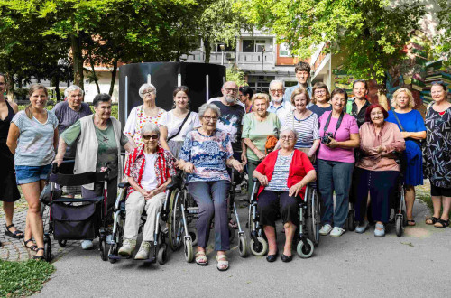 A group photograph of the residents of the Centre Retirement Home in Ljubljana, taken outdoors.