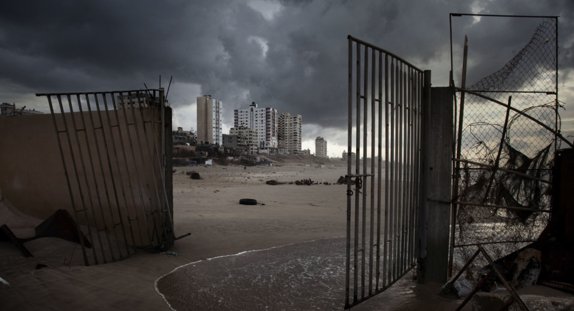 Gaza City apartment buildings rise beyond the broken gates of a waterfront restaurant Gaza 2011 Paolo Pellegrin MagnumPhotos