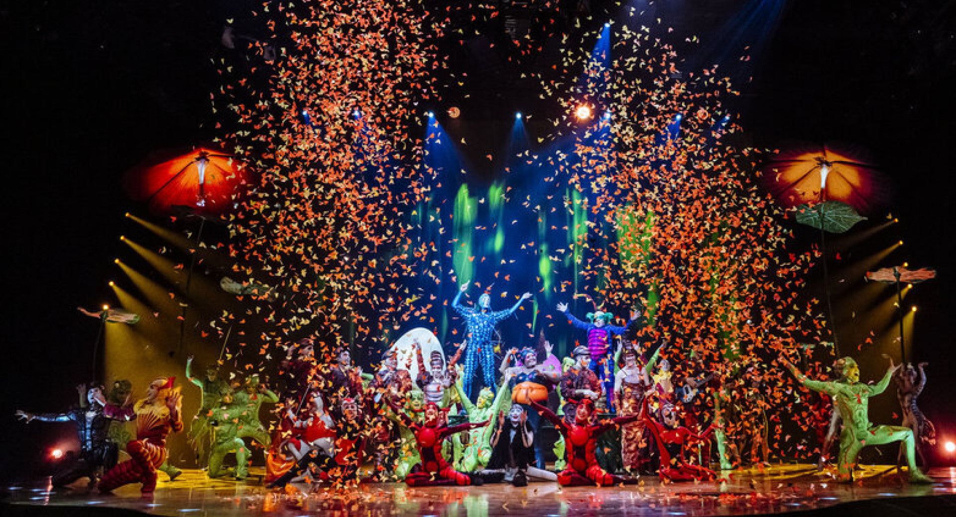 A circus on stage with confetti in the air.