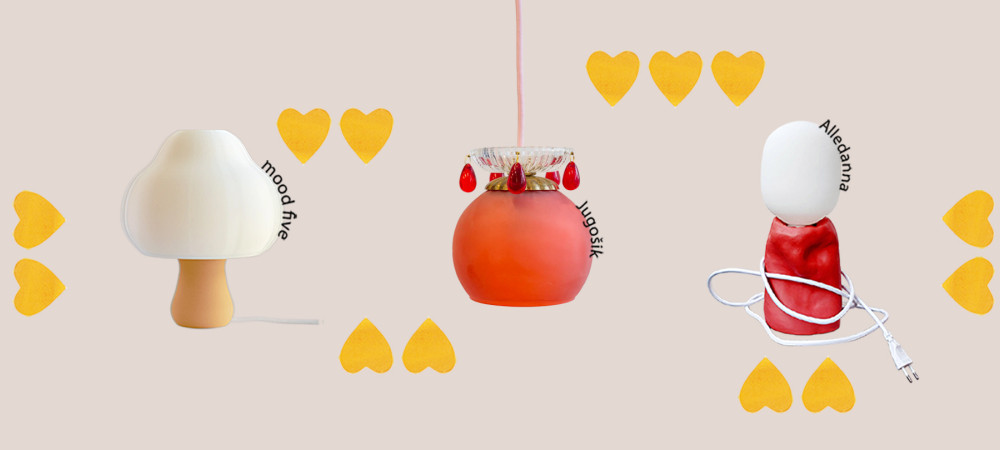 Three different table lamps on a white base, surrounded by yellow hearts.