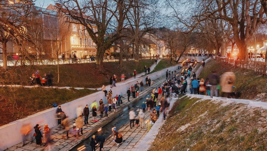 Nabrezja reke z ljudmi na levem in desnem bregu.
