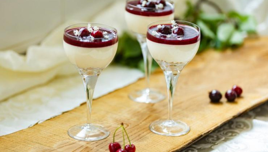 Three glasses with white chocolate and fruit sauce.
