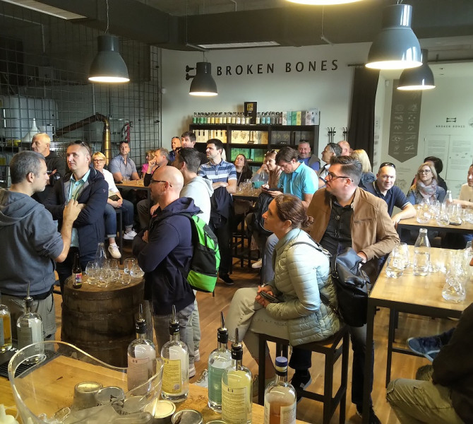 A group of people sitting at tables, enjoying drinks.