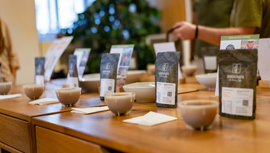 Cups and bags of coffee on the table.
