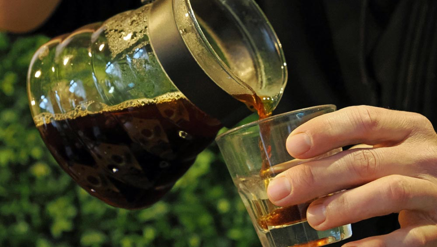 Pouring coffee into a glass.