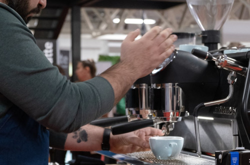 A man is pouring coffee into a cup.