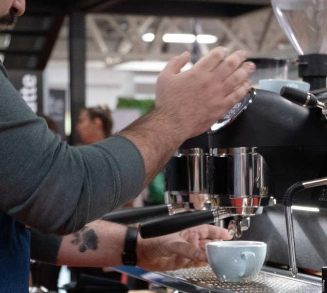 A man is pouring coffee into a cup.
