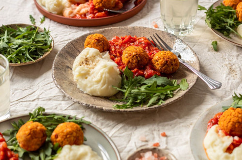 Vegan Lentil Croquettes on a Bed of Vegetables, served with a side dish.