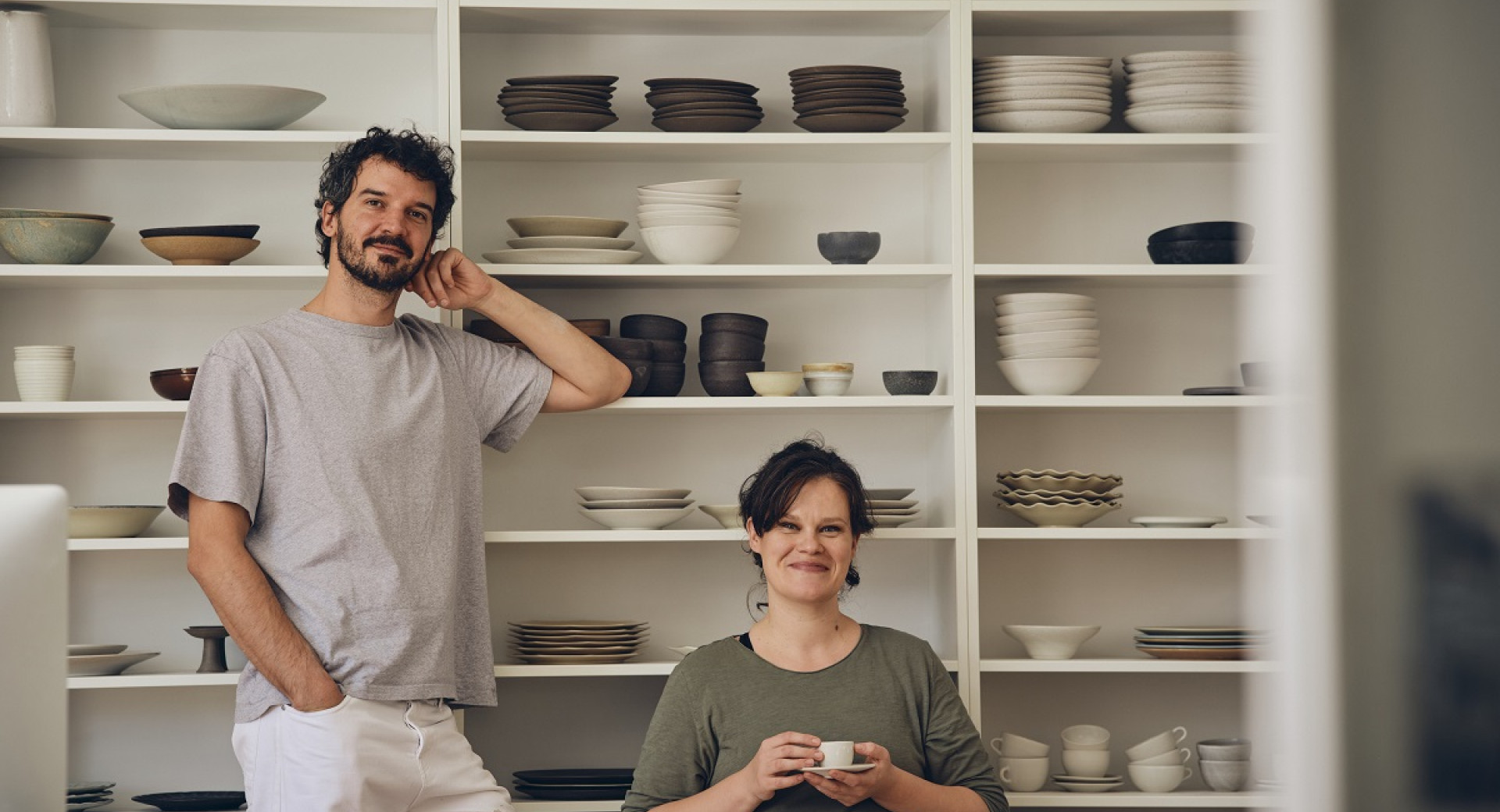 Moski in zenska pred belo omaro s keramiko.