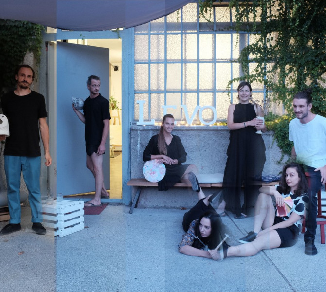 A group of artists posing outside a creative studio, holding ceramic pieces, with ivy-covered walls in the background.