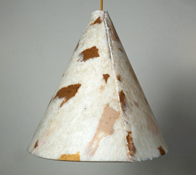 A white bell-shaped light with brown stains.