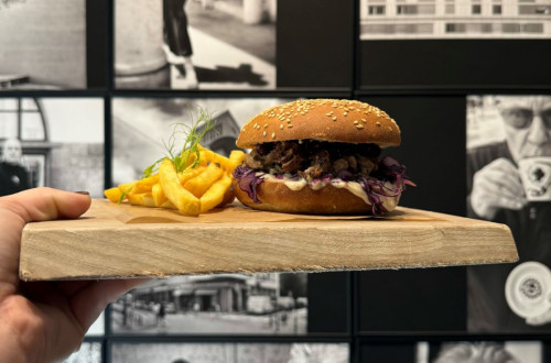  Burger with fries on a wooden board.