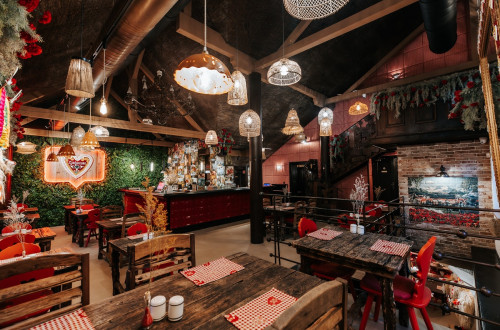 The interior of the restaurant with wooden furniture and a homely atmosphere.