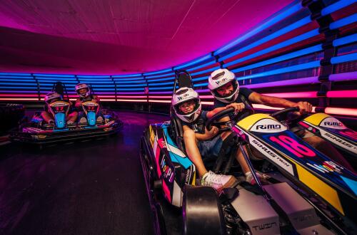 Two young men in a go-kart on the track.