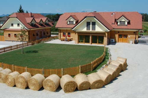 The lawn in front of the house, surrounded by bales of hay.