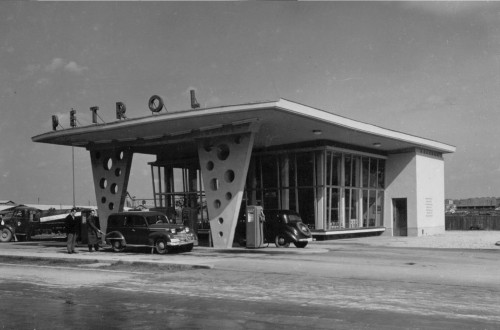 Black-and-white photograph of an old petrol station.