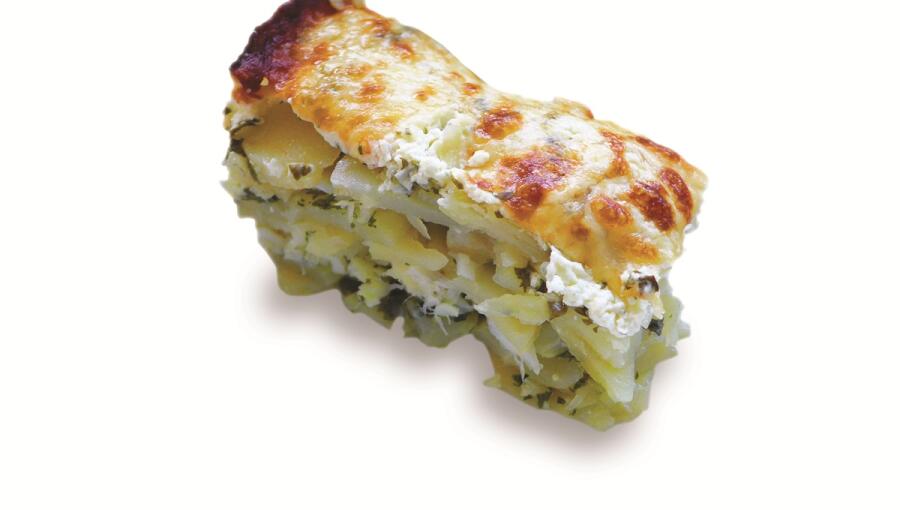 A layer of potato, cream cheese, and herbs, topped with a golden, crispy crust and soft layers inside.