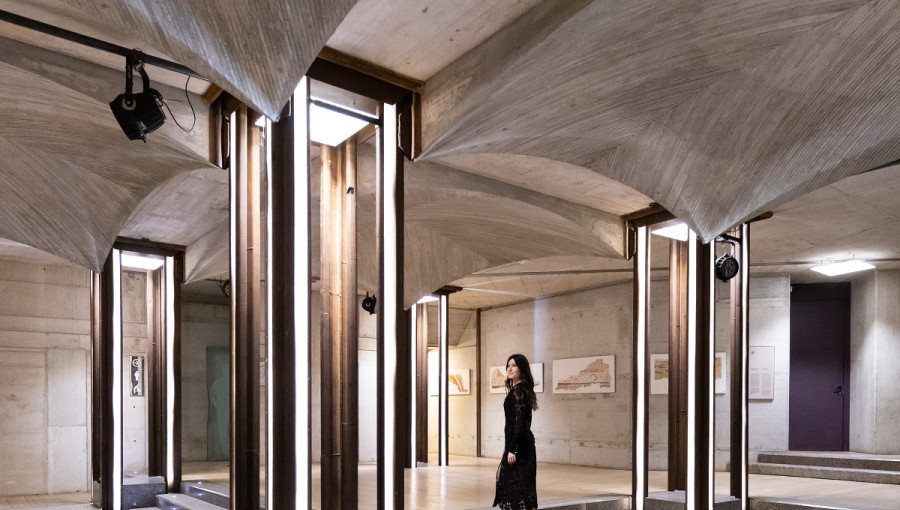 A room with a lot of stairs. A young woman in the middle.