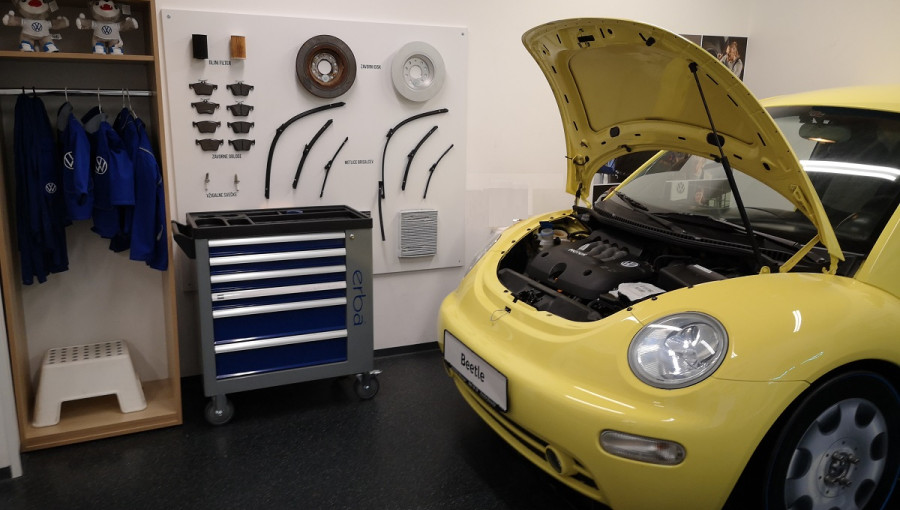 A yellow car as a part of a children's car workshop.