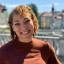 Smiling woman with curls.