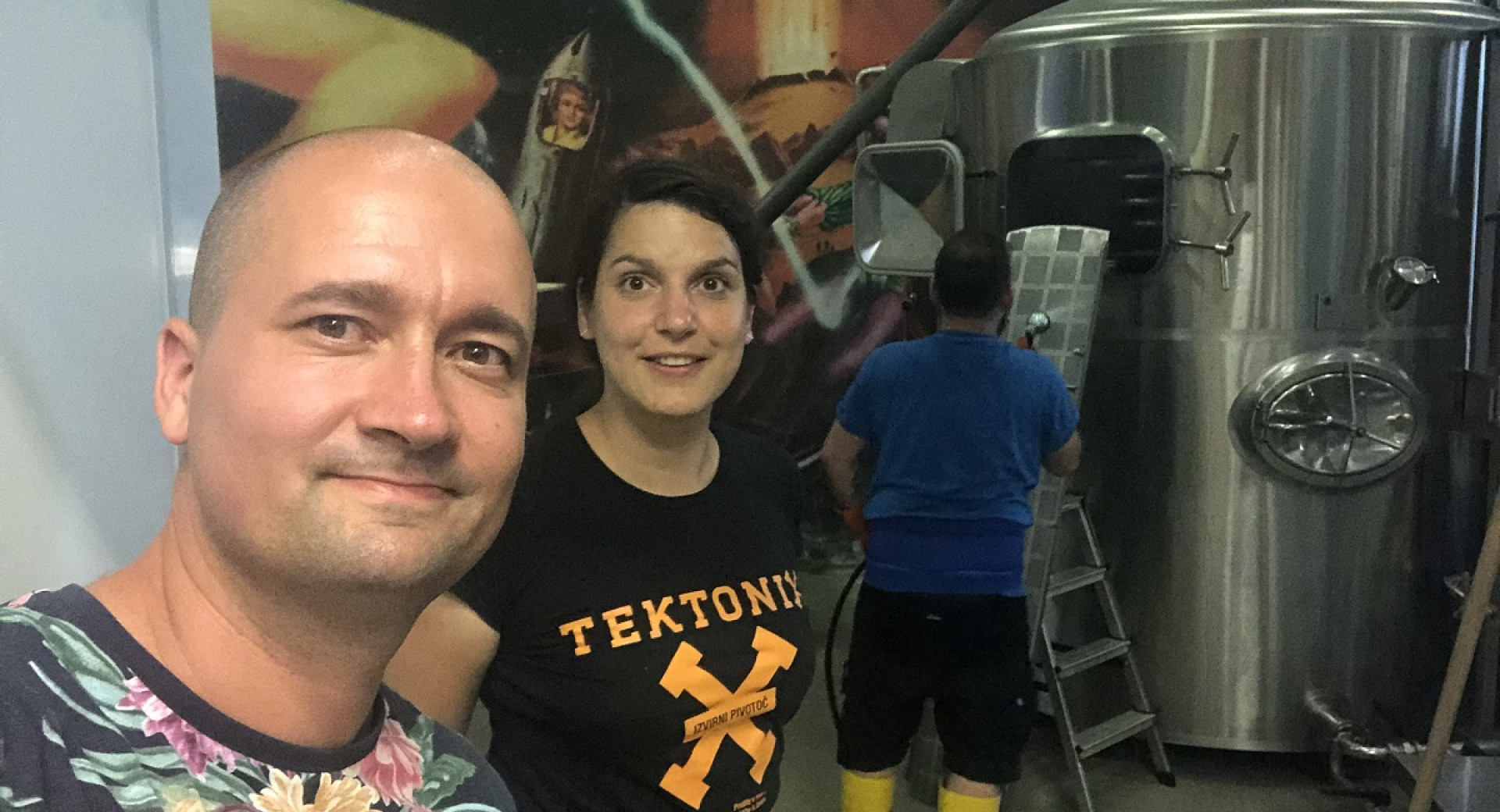 A man and a woman in front of a beer barrel.