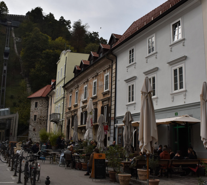 A castle on the hill. A row of town houses below him.