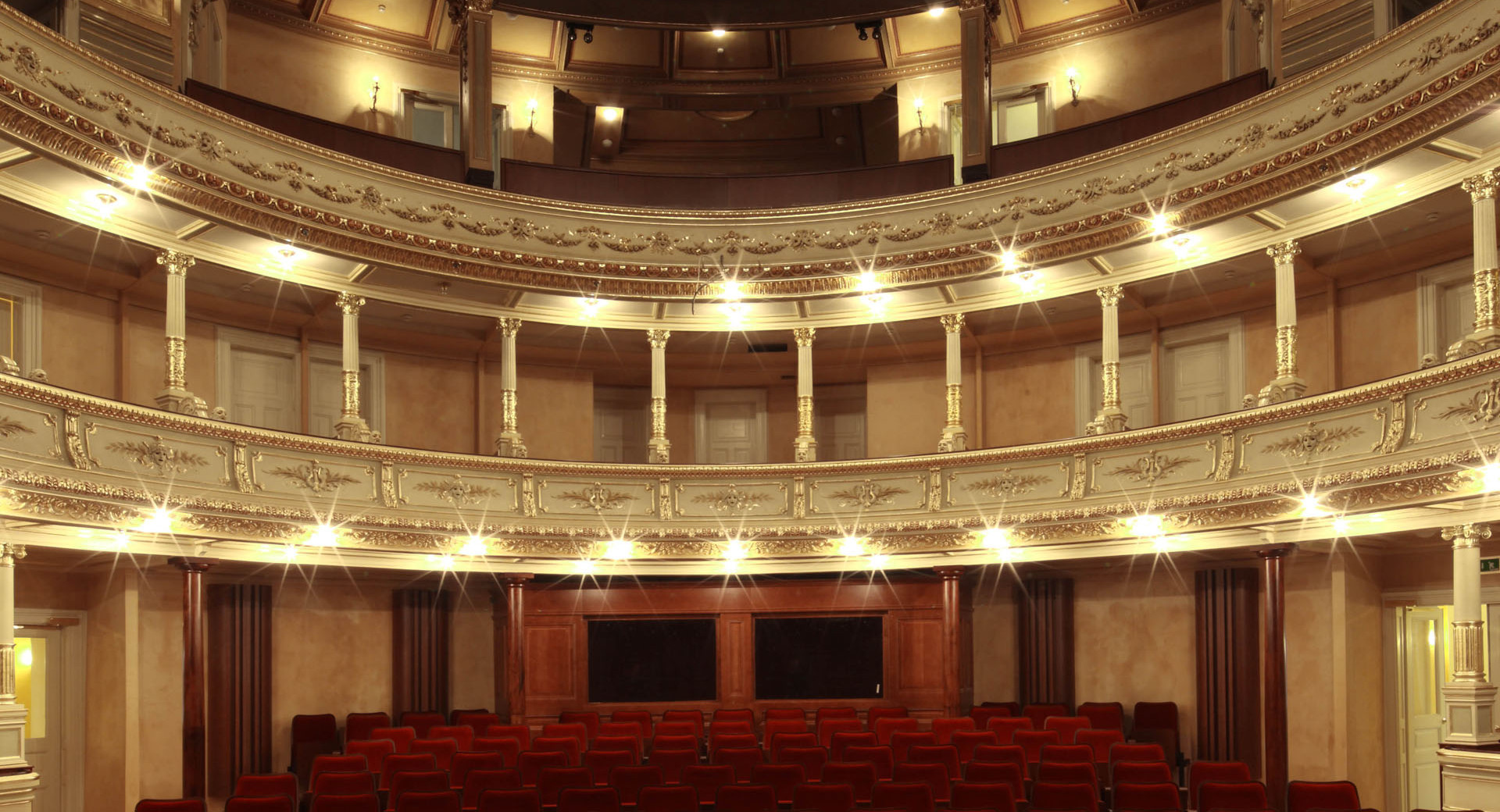 The interior of an opera house with balconies. 