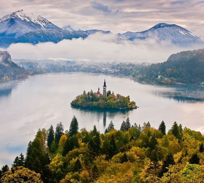 Small island in the middle of the lake, with a small church on it.