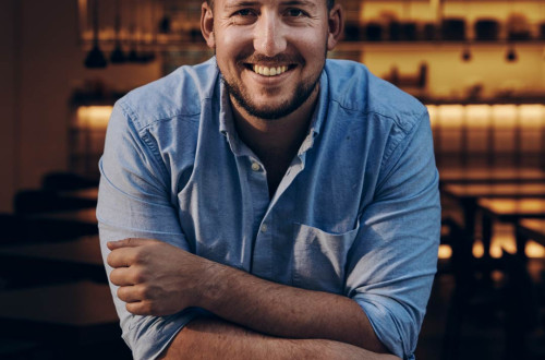 Smiling man in a blue shirt.