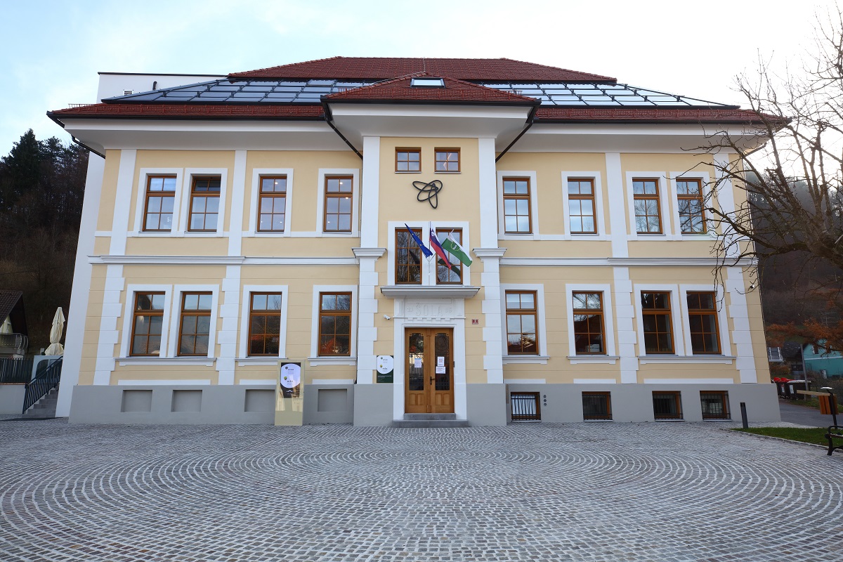 A large yellow building with a bee on the facade.