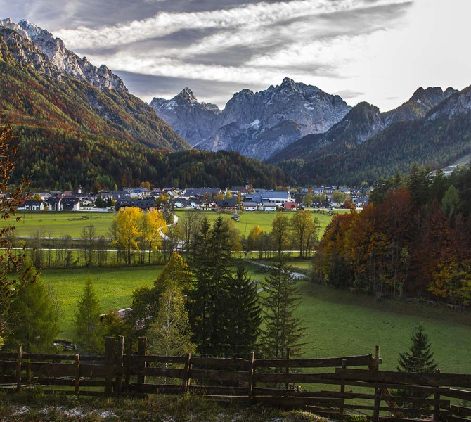 A town beneath the mountains in autumn colors.