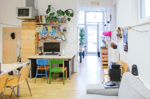 A large room with tables and chairs and numerous creativity tools.